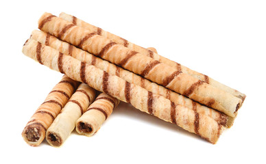 Heap of striped wafer tubules with the chocolate cream, isolated