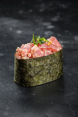 Gunkan maki sushi with tuna on black background