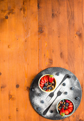 Cereal. Breakfast with muesli, and fresh fruits in bowls on a rustic wooden background,