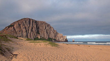 Morro Rock at sunrise at Morro Bay Beach State Park popular vacation / camping spot on the Central California Coast USA