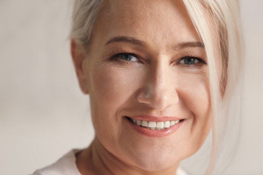 Portrait of smiling mature woman at home, closeup