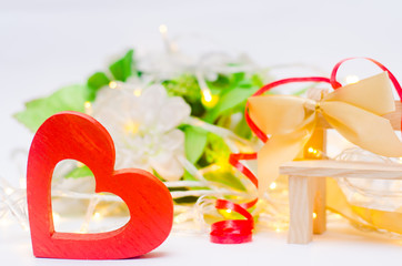 wooden heart with a bow on a bench on a white background. Valentine's Day