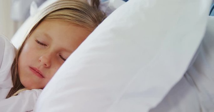Girl sleeping peacefully on bed 