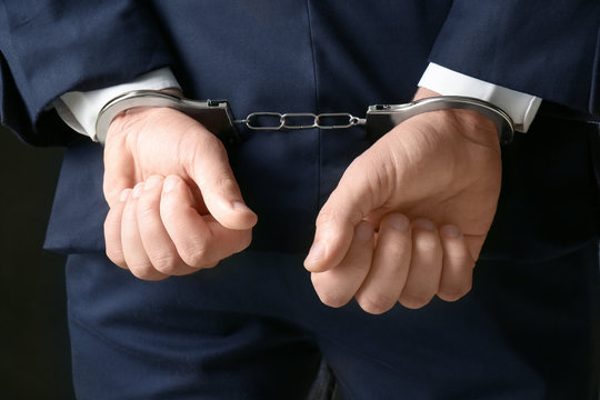 Businessman in handcuffs, closeup