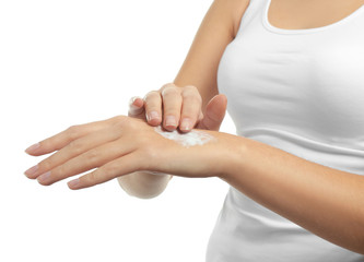 Beautiful young woman applying hand cream on white background, closeup