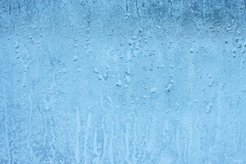 Closeup shot of a steamy window with water drops made in dull day
