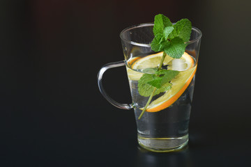 still life of fresh fruits and herbs on a dark background close up