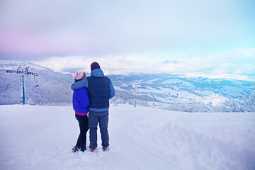 Fototapeta na wymiar Couple enjoying the beauty of ski mountain resort