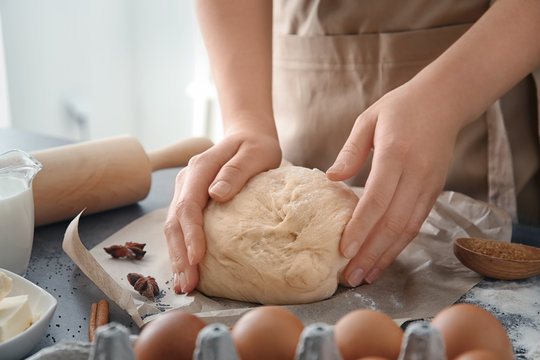 Woman with dough on table, closeup