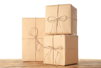 Parcel gift boxes on wooden table against white background