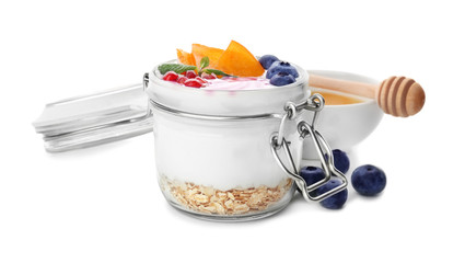Yogurt with fruits in jar on white background