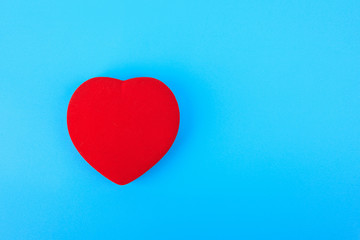 one bright red heart on a blue background