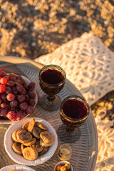 Outdoor table arrangement with glasses of wine, dried fruits