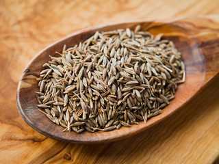 Cumin Seeds on wooden spoon -  macro, closeup.