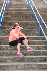 female athlete having a post workout drink