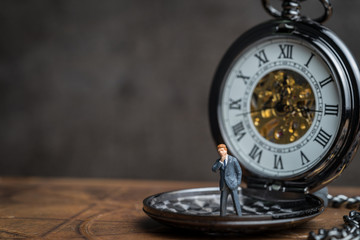 Time prove for business success concept, miniature people businessman standing on vintage pocket watch - Powered by Adobe