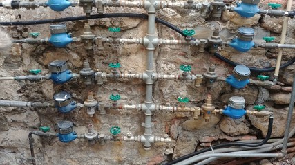 Hydraulic domestic system with counters on the outer wall of a building in San Remo