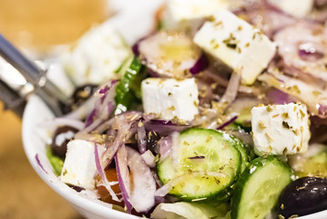 Fresh salad closeup, healthy food. Greek salad with feta cheese, macro food.