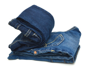 Stack of blue jeans on white background