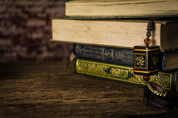 muhammad prophet of Islam with Koran - holy book of Muslims ( public item of all muslims ) on the table , still life © meen_na