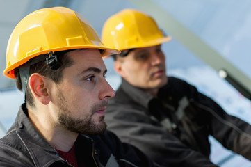 Two maintenance engineer work on relay protection system