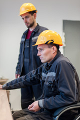 Two maintenance engineer work on relay protection system