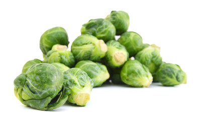 freshly brussel sprouts and some whole ones on a white background