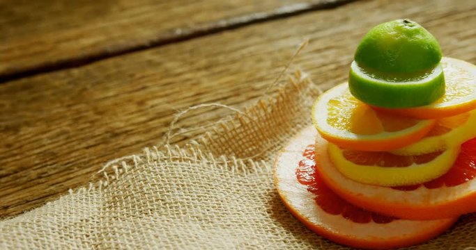 Various citrus slices stack on jute fabric  