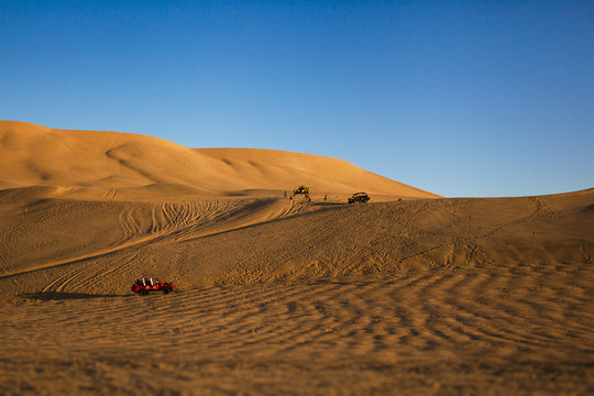 Huacachina Peru, buggies on the dunes above desert 