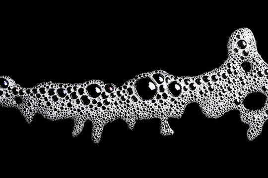 White washing foam shape isolated on black.