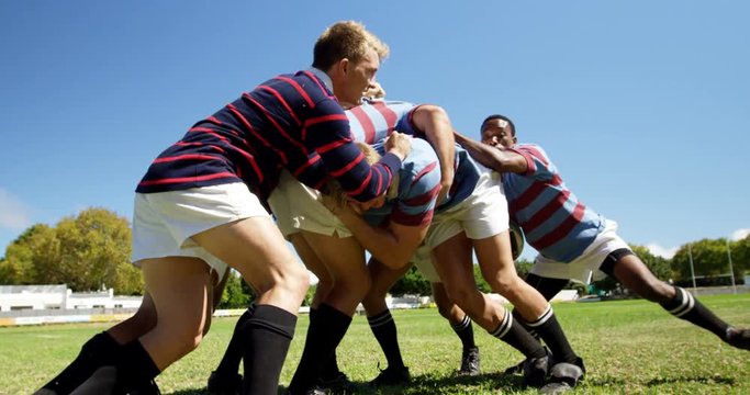 Rugby players playing rugby on the field  