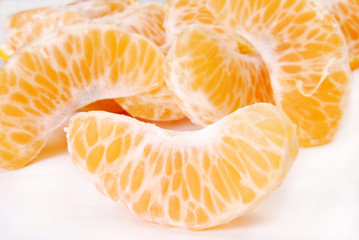 Slices of peeled orange on white background      