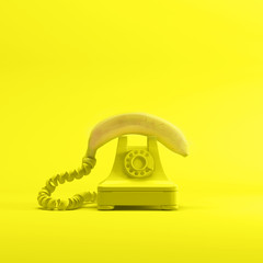 Banana phone with yellow vintage telephone on yellow color background. minimal idea concept.