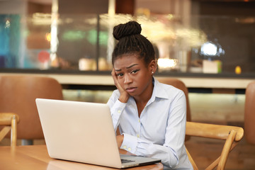 Fototapeta na wymiar Black girl with laptop tired with studies