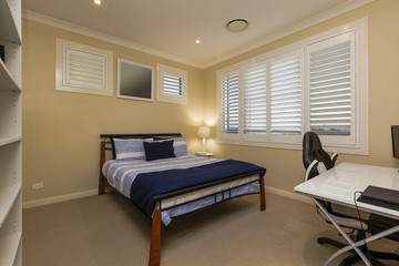 Empty bedroom with bed, desk and chair