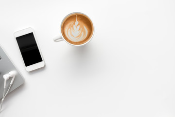 White office workspace with eye glasses,laptop,smart phone and cup of coffee.Top view with copy space.
