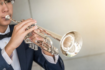 Trumpet instrument and Musician playing a trumpet in studio
