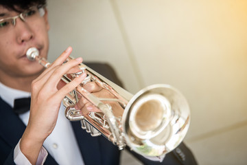 Trumpet instrument and Musician playing a trumpet in studio
