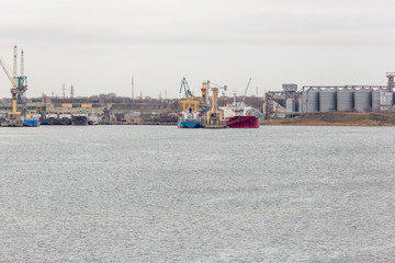 Fototapeta premium Port grain elevator. Industrial sea trading port bulk cargo zone grain terminal