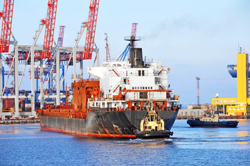Tugboat assisting bulk cargo ship