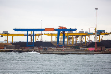 coal terminal of seaport. Heaps of coal in port awaiting loading on ship and shipment all over the...