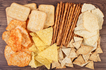 Heap of salted crisps, breadsticks and cookies, concept of unhealthy food