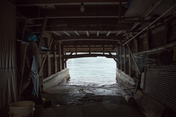 The boat house at Ine Boathouse is a traditional fishing village on a rainy day in Kyoto, Japan.