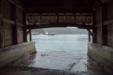 The boat house at Ine Boathouse is a traditional fishing village on a rainy day in Kyoto, Japan.