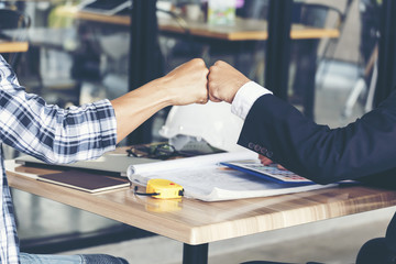 Business Partners Trust in Team Giving Fist Bump to Greeting Start up project Contractor.Businessman Teamwork are Partnership in Office Team Meeting with Hands together. Industry Business Work Concept