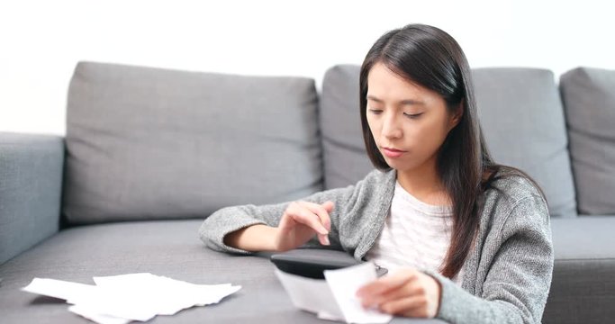 Woman counting expense with calculator