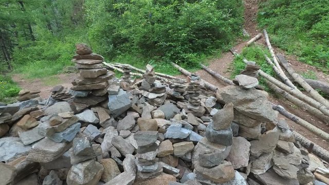 Fairy castle of stones in the forest. Buildings of stone, figures. Balanced stones stand firmly. Taken very close to a wide angle.
