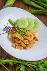 Fried dry buffalo skin on wooden table, Thai food, Laos food.