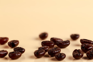 Roasted fresh coffee beans on a light background