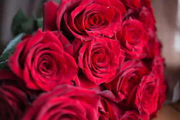 bouquet of red roses on the windowsill